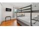 Bedroom with a bunk bed, TV, and hardwood floors at 11302 Southwind Lake Dr, Gibsonton, FL 33534