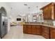 Kitchen with island, granite counters, and views into living room at 11302 Southwind Lake Dr, Gibsonton, FL 33534