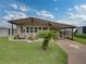 Single-wide manufactured home with carport and landscaped lawn at 35027 Wagner Way, Zephyrhills, FL 33541