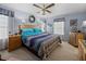 Spacious main bedroom with ceiling fan, large bed, and wood furniture at 35027 Wagner Way, Zephyrhills, FL 33541