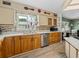Updated kitchen with wood cabinets, tile backsplash, and stainless steel appliances at 35027 Wagner Way, Zephyrhills, FL 33541