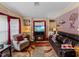 Relaxing living room featuring a fireplace and large TV at 35027 Wagner Way, Zephyrhills, FL 33541