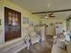 Bright sunroom features comfy seating, a ceiling fan, and access to the outdoors at 35027 Wagner Way, Zephyrhills, FL 33541