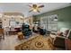 Relaxing living room featuring a ceiling fan, comfy seating, and a large area rug at 35027 Wagner Way, Zephyrhills, FL 33541