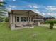 Tan single-story home with covered carport and landscaping at 35027 Wagner Way, Zephyrhills, FL 33541