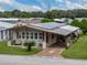 Single-story home with carport, nicely landscaped yard, and star-shaped driveway at 35027 Wagner Way, Zephyrhills, FL 33541