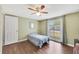 Light and airy bedroom with wood flooring and ceiling fan at 7314 Parrot Dr, Port Richey, FL 34668