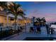 Backyard patio with pool and water view at dusk at 4923 W Melrose N Ave, Tampa, FL 33629