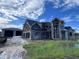 Exterior of a new home under construction with scaffolding and block work at 8100 Spring Forest Ln, Wesley Chapel, FL 33544