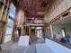 Interior under construction, showcasing an open floor plan with a staircase and high ceilings at 8100 Spring Forest Ln, Wesley Chapel, FL 33544