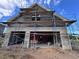 New construction home exterior with two-car garage and scaffolding at 8100 Spring Forest Ln, Wesley Chapel, FL 33544