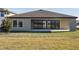 Exterior of home with large backyard and sliding glass doors at 12977 Long Valley Cir, Spring Hill, FL 34609