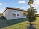 A well-maintained backyard featuring lush green grass and a healthy young tree at 12977 Long Valley Cir, Spring Hill, FL 34609