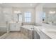 Bright bathroom featuring a large tub, double sinks, glass enclosed shower, and a makeup vanity at 12977 Long Valley Cir, Spring Hill, FL 34609
