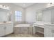 Bathroom featuring a soaking tub, dual vanities, and tiled floor at 12977 Long Valley Cir, Spring Hill, FL 34609