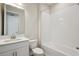 Bright bathroom with white tiled shower-tub, toilet, and sink with vanity at 12977 Long Valley Cir, Spring Hill, FL 34609