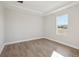 Sunny bedroom with hardwood floors, neutral paint, and a bright window view at 12977 Long Valley Cir, Spring Hill, FL 34609