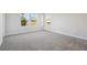 A bedroom with carpet flooring and natural light from the windows at 12977 Long Valley Cir, Spring Hill, FL 34609