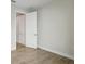 Neutral bedroom featuring wood-look flooring and an open doorway at 12977 Long Valley Cir, Spring Hill, FL 34609