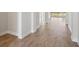 Hallway features wood floors, leading to the kitchen with an outdoor view at 12977 Long Valley Cir, Spring Hill, FL 34609