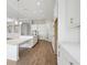 Bright, open kitchen featuring white cabinets, stainless steel appliances, and a large island with stone countertops at 12977 Long Valley Cir, Spring Hill, FL 34609