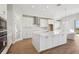Well-equipped modern kitchen boasting white cabinets, stainless steel appliances, and an oversized island at 12977 Long Valley Cir, Spring Hill, FL 34609