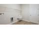 Well-lit laundry room featuring sink, storage, and wood-look flooring at 12977 Long Valley Cir, Spring Hill, FL 34609