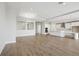 Spacious open-concept living area with modern flooring flowing into the kitchen at 12977 Long Valley Cir, Spring Hill, FL 34609
