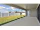Covered patio overlooking a landscaped backyard with privacy fence at 12977 Long Valley Cir, Spring Hill, FL 34609