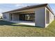 A modern patio with large sliding doors seamlessly connecting indoor and outdoor living spaces at 12977 Long Valley Cir, Spring Hill, FL 34609