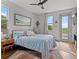 Main bedroom with a light blue comforter and access to a balcony at 2600 Quincy S St, Gulfport, FL 33711