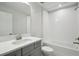 Bathroom featuring white subway tile tub and shower and vanity with a white countertop at 3437 Yellow Leaf Cir, Spring Hill, FL 34609