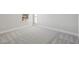 Bright bedroom with neutral carpeting, base trim and natural light from a window at 3437 Yellow Leaf Cir, Spring Hill, FL 34609