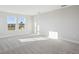 Bright and airy bonus room with soft carpeting and natural light from the double windows at 3437 Yellow Leaf Cir, Spring Hill, FL 34609
