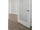 Modern interior glass door with chrome handle and wood-style flooring at 3437 Yellow Leaf Cir, Spring Hill, FL 34609