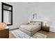 Bright bedroom with a comfortable bed, nightstands, and a large window at 490 Laguna Dr, Tierra Verde, FL 33715