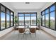 Elegant dining room with water views and modern light fixture at 490 Laguna Dr, Tierra Verde, FL 33715