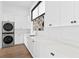 Bright laundry room with white cabinets and modern appliances at 490 Laguna Dr, Tierra Verde, FL 33715