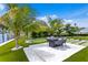 Landscaped patio with outdoor seating and putting green at 490 Laguna Dr, Tierra Verde, FL 33715