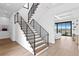 Modern staircase with metal railing and hardwood floors at 490 Laguna Dr, Tierra Verde, FL 33715