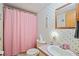 Simple bathroom with pink floral wallpaper and a shower at 34045 Brown Bayou, Wesley Chapel, FL 33543