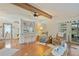 Living room with hardwood floors, comfortable seating and a view into the kitchen at 34045 Brown Bayou, Wesley Chapel, FL 33543