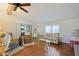Bright living room featuring hardwood floors, a vaulted ceiling, and comfortable seating at 34045 Brown Bayou, Wesley Chapel, FL 33543
