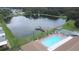 Aerial view of community pool, lake, and homes at 34045 Brown Bayou, Wesley Chapel, FL 33543