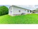 Exterior view of a single-wide mobile home with vinyl siding and a green lawn at 34045 Brown Bayou, Wesley Chapel, FL 33543