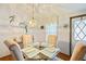 Glass dining table with four chairs in a well lit area at 34045 Brown Bayou, Wesley Chapel, FL 33543