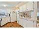 White kitchen with breakfast bar and view into living room at 34045 Brown Bayou, Wesley Chapel, FL 33543