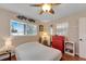 Cozy bedroom with red dresser and ceiling fan at 4103 24Th W Ave, Bradenton, FL 34205