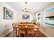 Bright dining room features a wood table with four chairs, hardwood floors and decorative accents at 8447 Deauville N, Pinellas Park, FL 33781