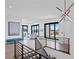 Bright landing with hardwood floors, modern light fixture, and water views at 490 Laguna Dr, Tierra Verde, FL 33715